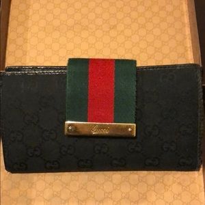 Gucci black with green/red webbing wallet.